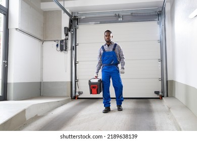 Garage Door Installation And Repair At Home. Contractor Man In House - Shutterstock ID 2189638139