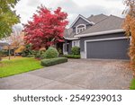 Garage door in luxury house with trees and nice landscape in Fall in Vancouver, Canada, North America. Day time on November 2024.