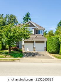 Garage Door In Luxury House With Trees And Nice Landscape