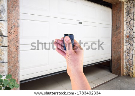 Garage door PVC. Hand use remote controller for closing and opening garage door 