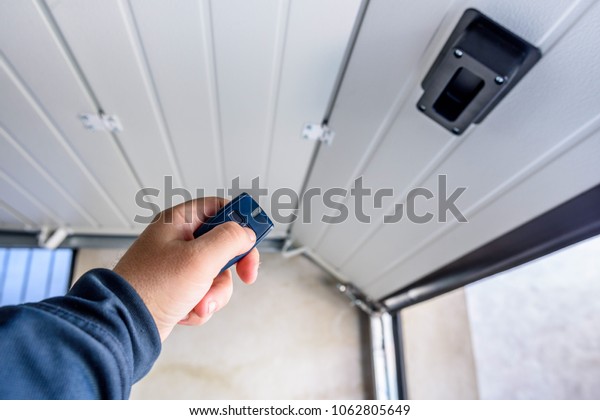 Garage door PVC. Hand use remote controller for\
closing and opening garage\
door.