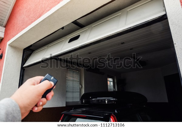 Garage door PVC. Hand use remote controller for\
closing and opening garage\
door.\
