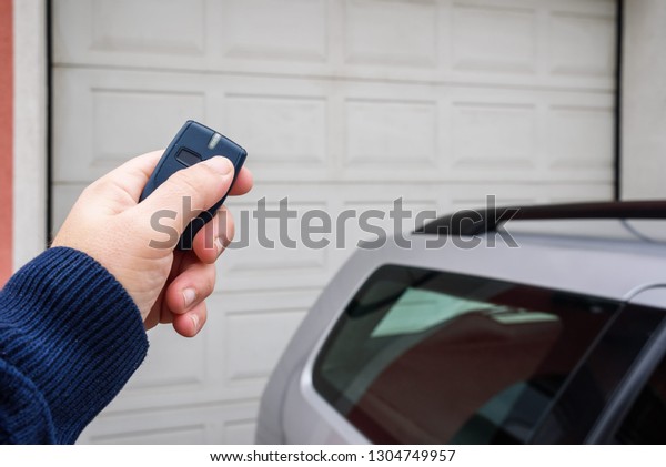 Garage door PVC. Hand use remote controller for\
closing and opening garage\
door\
