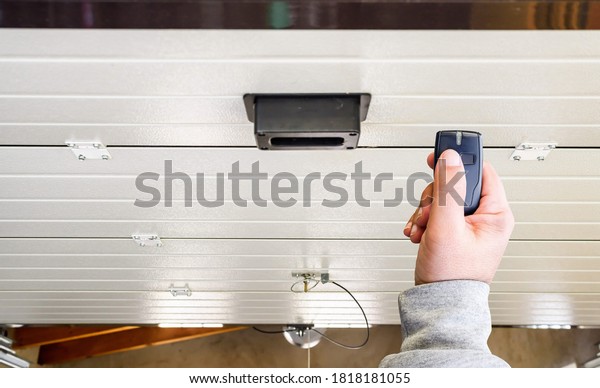 Garage door PVC. Hand use remote controller for\
closing and opening garage door\
