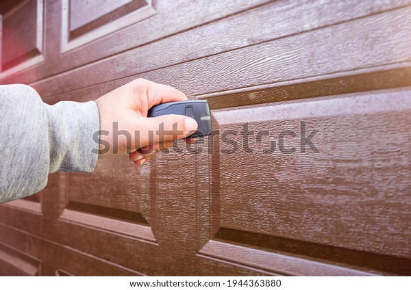 Garage door PVC. Hand use remote controller for\
closing and opening garage door\
