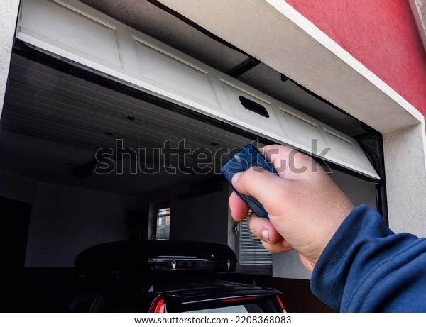 Garage door PVC. Hand use remote controller for\
closing and opening garage\
door\
