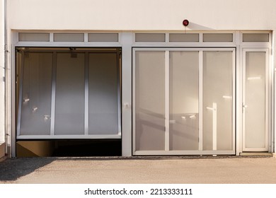 Garage Door To Underground Car Parking Of Apartment Building. Modern Sectional Gate To Garage Parking.