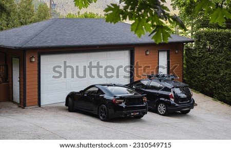 Garage door with wide driveway in Vancouver, Canada. Garage door in luxury house. Street photo, nobody, selective focus