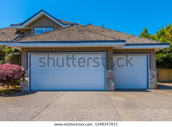 Garage, garage doors and\
driveway.