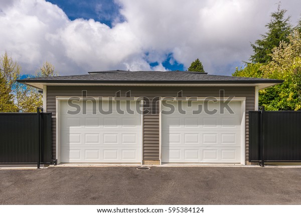 Garage, garage doors with\
driveway.