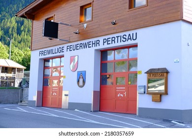 Garage Fire Station Building With Red Doors Volunteer Fire Brigade In Austria, Volunteering Concept, Fire Fighting And Community Assistance, Pertisau, Austria - June 2022