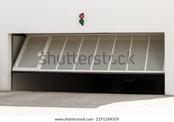 Garage\
Gate or Door Opening to Underground Car Parking. Modern Automatic\
Garage Gate with Entrance Door and Lamp Indicator\
