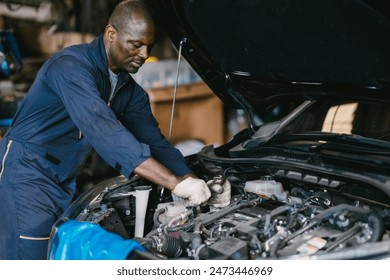 Garage Mechanic African Black male professional working car auto service checking engine oil at front hood. - Powered by Shutterstock