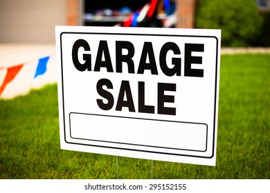 Garage Sale Sign On The Front Yard Of A Suburban House