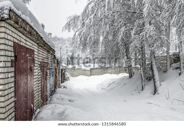 Garage\
society, cooperative society. Brick garages in the city, Russia.\
Consequences of a strong and unexpected\
snowfall.
