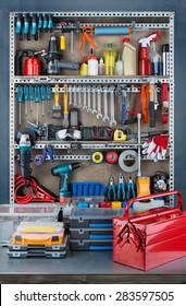 Garage Tool Rack With Various Tools And Repair Supplies On Board And Shelves.