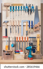 Garage Tool Rack With Various Tools And Repair Supplies On Board And Shelves.