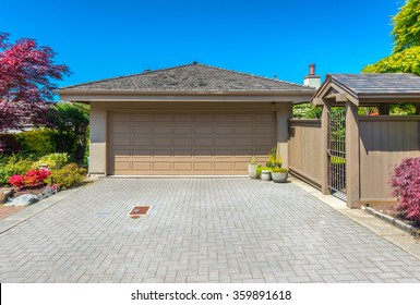 Garage With Wide, Long Nicely Paved Driveway.