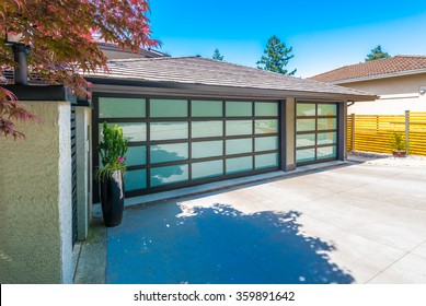 Garage With Wide, Long Nicely Paved Driveway.