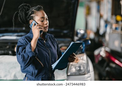 Garage women worker technician manager talking phone call with customer for service information. - Powered by Shutterstock