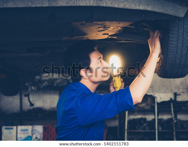 garage worker concept.handsome asia man\
automotive mechanic in garage with copy\
space