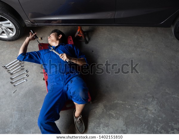 garage worker concept.handsome asia man\
automotive mechanic in garage with copy\
space