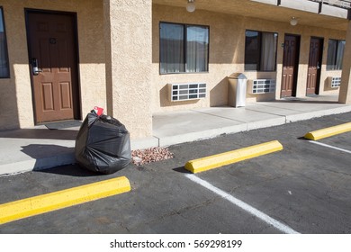 Garbage Bag Infront Of Motel Room And Parking Lot