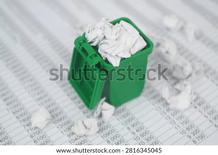 Garbage bin on financial documents. Сleaning city of garbage management.	
