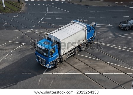 Garbage collection truck driving through the city with municipal waste