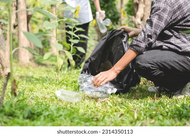 garbage collection, volunteer team pick up plastic bottles, put garbage in black garbage bags to clean up at parks, avoid pollution, be friendly to the environment and ecosystem. - Powered by Shutterstock