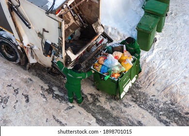 Garbage Collection Workers Pick Up Household Waste In Residential District In Winter