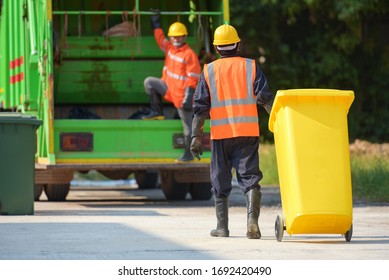Garbage collector Worker of urban municipal recycling garbage collector truck loading waste and trash bin - Shutterstock ID 1692420490