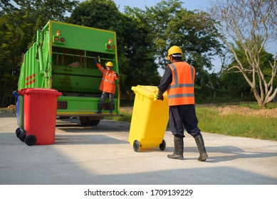 Garbage collector Worker of urban municipal recycling garbage collector truck loading waste and trash bin