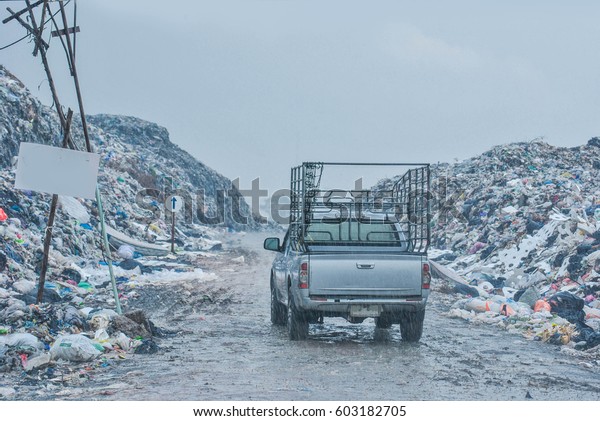 Garbage collectors are garbage trucks with cars.\
And the cart pulled out of the junk on a cloudy day, low light and\
heavy rain.\
