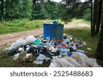 Garbage dump on beach at lake. People throw garbage near lake in nature. Trash at camping resort. Pile of rubbish in nature. Environmental pollution and ecology. Illegal dumping of Garbage near river 