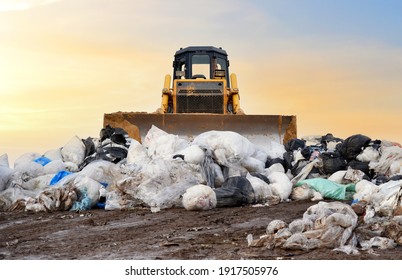 Garbage dump with plastic bags and food waste. Recycling of construction waste on junk yard. Refuse collection. Bulldozer dispose of rubbish at a landfill. Trash disposal area. Dozer on rubbish dump  - Shutterstock ID 1917505976