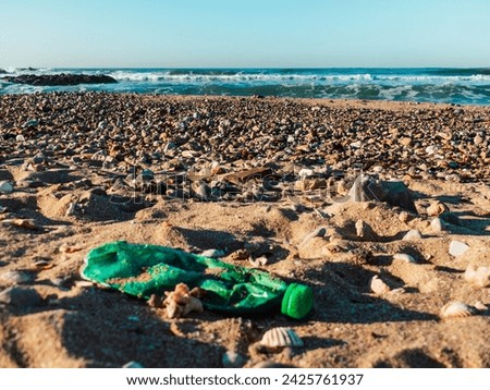 Garbage dumped on the urban beach. Empty and dirty plastic bottle. Pollution. Uncivility
