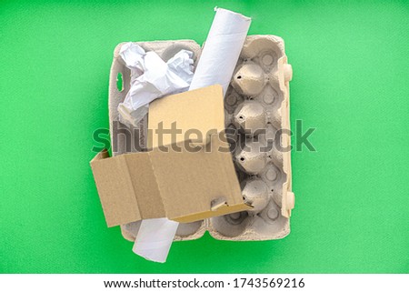 garbage, ecology, garbage sorting concept - layout of waste sorting into 4 types: glass, plastic, paper, metal on a green background copy space.