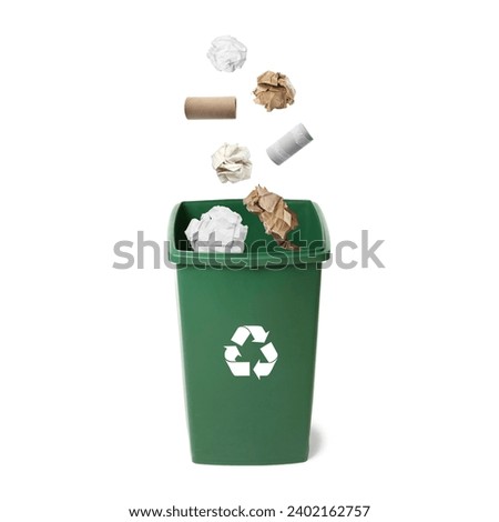 Garbage falling into trash bin on white background