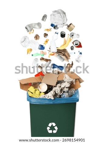 Garbage falling into trash bin with recycling symbol on white background