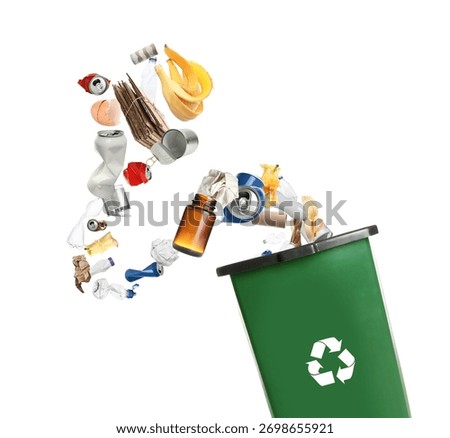 Garbage falling into trash bin with recycling symbol on white background