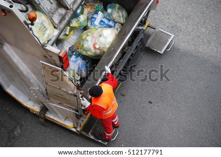 Garbage man at work on the truck 