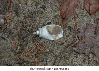 Garbage From An Old Gray Metal Spray Can Lie On The Ground And Fallen Brown Fallen Leaves In Nature