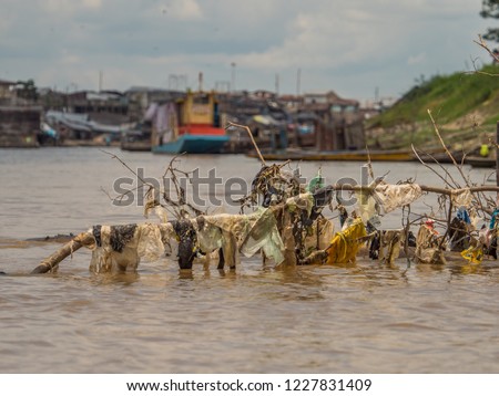 Garbage on the brach in  the Itaya River during low water season in Amazon junle. Belén district of Iquitos, Peru