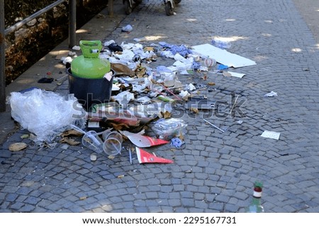 lot of garbage on sidewalk in Park, on city street, garbage dump after the holiday, garbage collection, do not litter in public places, environmental protection, waste recycling