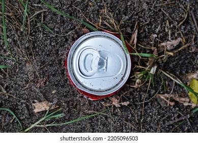 Garbage From One Round White Aluminum Can Lies On The Gray Ground On The Street