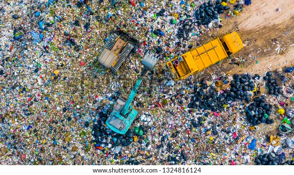 Garbage pile in trash dump or junkyard,\
Aerial view garbage metal truck unload garbage consumption junkyard\
scarp, Global warming, Ecosystem and healthy environment concepts\
and background.
