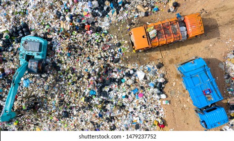 Garbage pile in trash dump or open landfill, Trash trucks dump waste products polluting in an trash dump, Surface and subsurface water contamination, modern hydraulic. Aerial top view