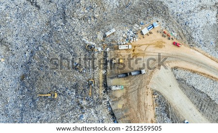 Garbage pile in trash dump or open landfill, Trash trucks dump waste products polluting in an trash dump, Surface and subsurface water contamination, modern hydraulic. Aerial top view