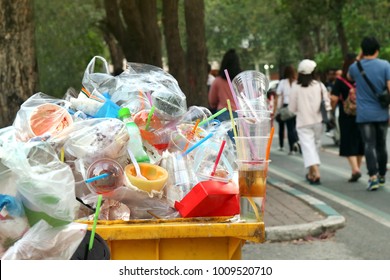 Garbage plastic Waste trash full of trash bin yellow and background people are walking on the sidewalk garden, Garbage bin, Trash plastic pollution, Garbage, Waste, Plastic Waste